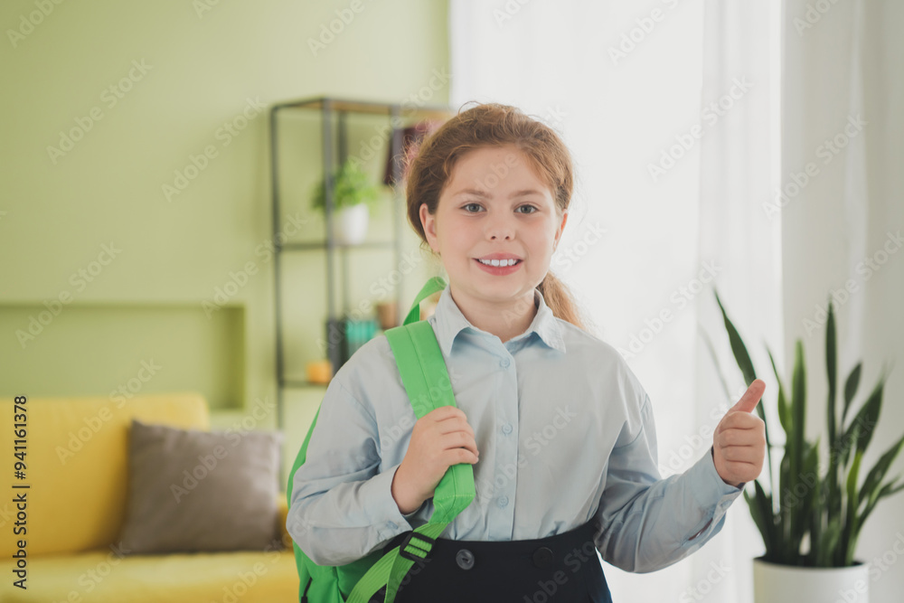 Poster Photo of charming sweet adorable girl learner wearing uniform going school 1st september thumb up indoors