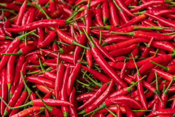 Pile of red spicy chili peppers at fresh market in Thailand.