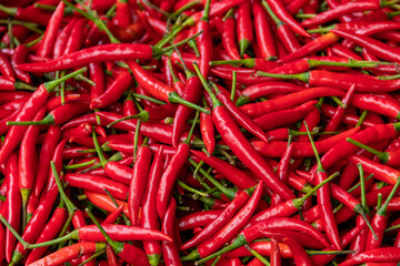 Pile of red spicy chili peppers at fresh market in Thailand.