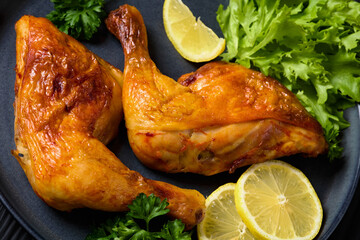 fried chicken legs with lettuce, lemon on plate