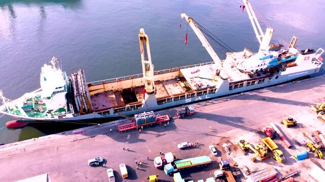 Cargo ships dock at the Harbour on a calm sea