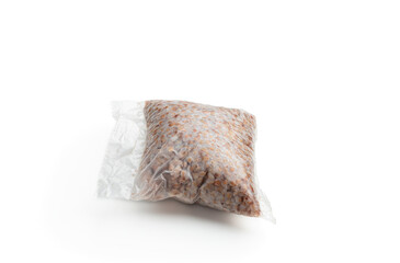 Plastic package with boiled buckwheat isolated on white background