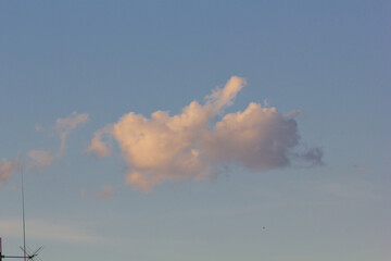 Sunset with clouds in the sky over a modern city.
