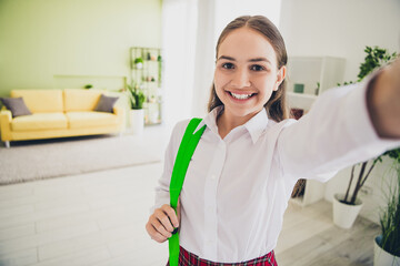 Photo portrait of cute adorable teen girl take selfie photo backpack wear uniform remote lesson education from home indoors