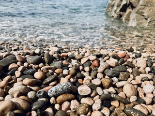Pebble beach on the sand in the Mediterranean Sea.