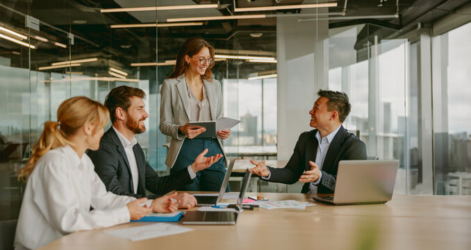 A collaborative business meeting involving professionals who are actively engaged in discussion and presentation