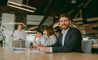 A vibrant and lively business meeting with professionals engaging in collaboration within a modern...