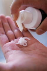 SPF, sun protection concept. Sunburn man back hands on shoulders. Close up Applying Sunscreen Cream. Skin and Body Care in summer. Man Using Skin protection foam.