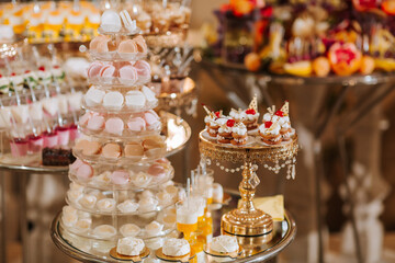 A table full of desserts including cakes, cupcakes, and other sweets