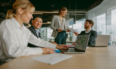 A highly professional team is thoroughly discussing innovative strategies and creative ideas in a...