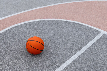 Basketball orange ball on colorful sport field with white line. Sports gear without people. Template, sport background. Team sport. Copy space.