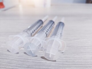 Syringe on a wooden table for medical equipment for vaccine equipment in the laboratory.