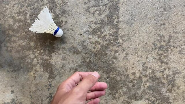 A man is throwing away the broken shuttlecock which has been used repeatedly. Concept for Badminton Practice