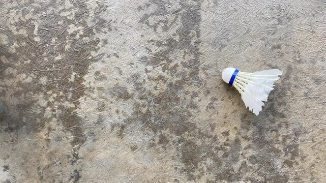 A man is throwing away the broken shuttlecock which has been used repeatedly. Concept for Badminton Practice