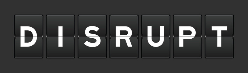 Black color analog flip board with word disrupt on gray background
