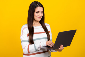 Naklejka premium Photo of mature brunette hair business lady using laptop computer during work session isolated on yellow color background