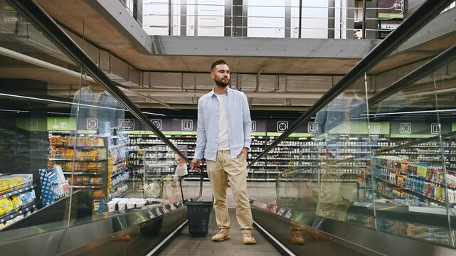 Man with basket on the escalator at the materials market building