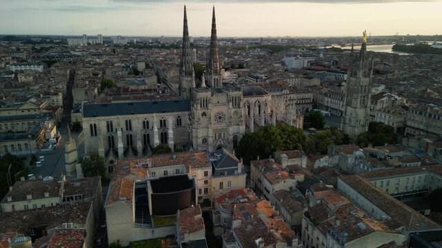 The drone aerial footage of Bordeaux Cathedral and Pey Berland Tower at sunrise, Bordeaux, France.