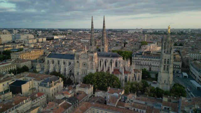 The drone aerial footage of Bordeaux Cathedral and Pey Berland Tower at sunrise, Bordeaux, France.
