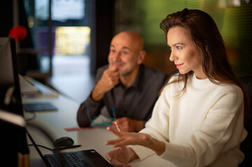 group of business people using computers during business meeting at working late at night in the office