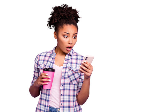 Portrait scared beautiful student afraid impressed astonished horrible information read use device rest relax weekend smm hold hand mug beverage trendy stylish plaid shirts isolated purple background