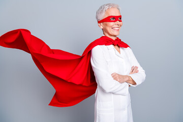 Photo of strong old lady scientist in super hero cloak crossing arms isolated grey color background