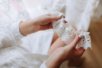 A woman is holding a lace train in her hand