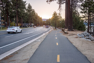 Empty bicycle lane along a road in a lakeside town at sunset in autumn. South Lake Tahoe, CA, USA.