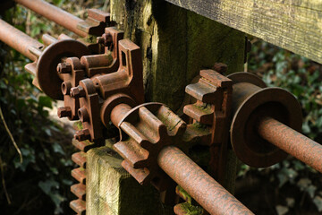 The cogs and workings of an old unused victorian sluice gate system now collecting rust.