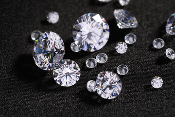 Many beautiful shiny diamonds on black fabric, closeup