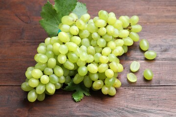Delicious fresh ripe grapes on wooden table