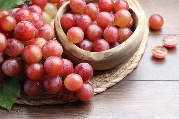 Fresh ripe grapes on wooden table, closeup