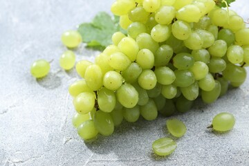 Fresh ripe grapes on grey table, closeup