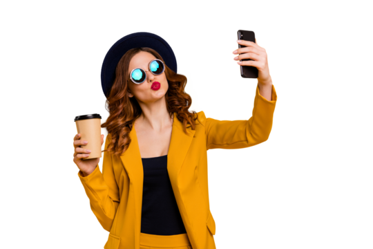 Close up photo beautiful she her lady send air kiss hands arms telephone make take selfies vacation traveler hot beverage paper container wear specs formal-wear suit isolated yellow bright background