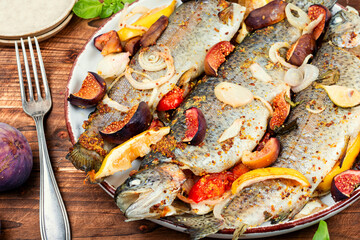 Whole grilled fish served with figs.