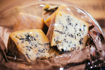 Different types of blue cheese on sale at a market.