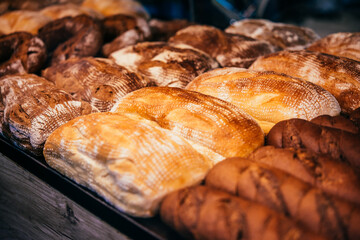 Different kinds of fresh bread on sale at a bakery of cafe.