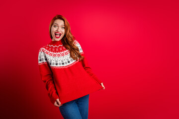 Photo of young lady demonstrate her beautiful present ugly ornament sweater for christmas holiday isolated on red color background