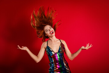 Photo of gorgeous pretty young woman throw flying hair shiny dress isolated on bright red color background