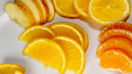 organic fresh orange, apple, malta decorated on white ceramic plate with close shot 