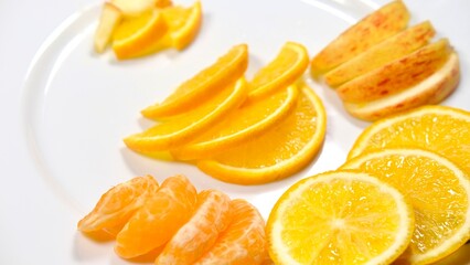organic fresh orange, apple, malta decorated on white ceramic plate with close shot 