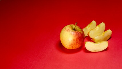Fresh apple cutting slice on red background 