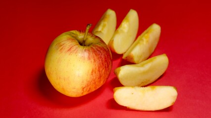 Fresh apple cutting slice on red background 