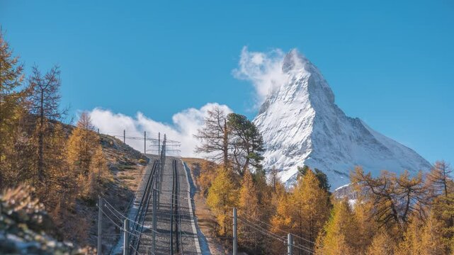 Zermatt Switzerland time lapse of Matterhorn mountain peak and Gornergrat bahn train in Autumn Season