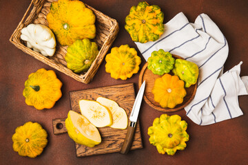 Pattypan zucchini on a textured kitchen table. squash. Fresh organic pattypan squashes on...