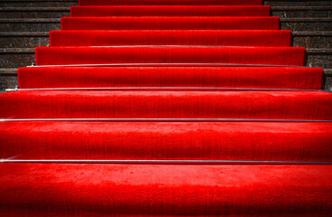 Red carpet on stairs and spotlight with light
