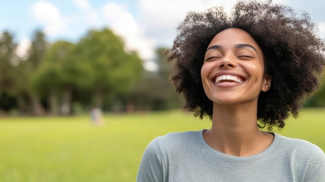 Radiant Young Woman Enjoying Sunny Day in Park