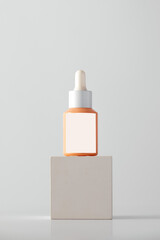 Dropper with anti-aging serum on the podium. Cosmetics, skin care.