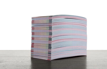 Stack of business cards on wooden table against white background