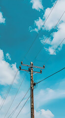 Fototapeta premium A high-voltage electric pole in the blue sky with a replica of space. The concept of energy supply.